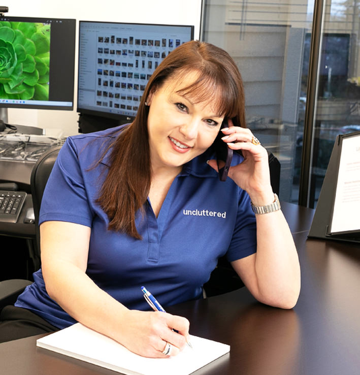 Linda taking notes at her office image