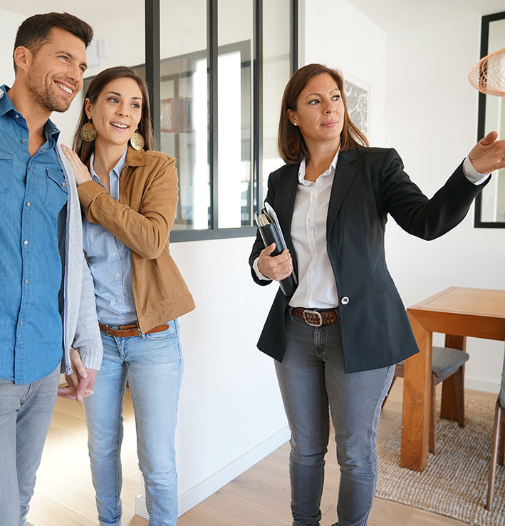 Real estate agent showing a home to prospective clients image